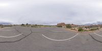 a fisheye lens captures a desert setting and street scene from the outside looking out