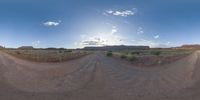 a fisheye lens captures a desert setting and street scene from the outside looking out