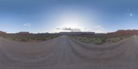 a fisheye lens captures a desert setting and street scene from the outside looking out