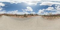 a fisheye lens captures a desert setting and street scene from the outside looking out