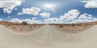 a fisheye lens captures a desert setting and street scene from the outside looking out