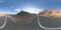 a fisheye lens captures a desert setting and street scene from the outside looking out