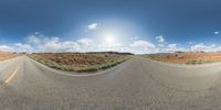 a fisheye lens captures a desert setting and street scene from the outside looking out