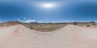 a fisheye lens captures a desert setting and street scene from the outside looking out