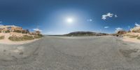 a fisheye lens captures a desert setting and street scene from the outside looking out