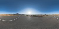 a fisheye lens captures a desert setting and street scene from the outside looking out