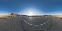 a fisheye lens captures a desert setting and street scene from the outside looking out