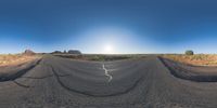 a fisheye lens captures a desert setting and street scene from the outside looking out