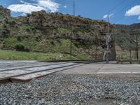 there is a rocky terrain surrounding the tracks with a train track in the middle of the frame