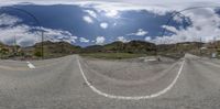 a view of a mountain road through google earth view glasses with a street light in the foreground