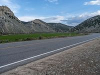 Utah Landscape: Road, Clouds, and Majestic Mountains