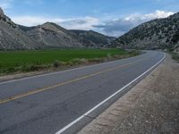 Utah Landscape: Road, Clouds, and Majestic Mountains