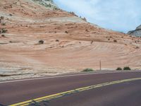 Utah Landscape: A Road Amongst Majestic Mountains and Clouds