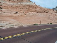 Utah Landscape: A Road Amongst Majestic Mountains and Clouds