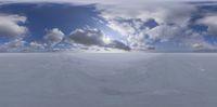 a snowboarding slope is surrounded by clouds and sun, and the camera has a zooming lens in it