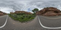 an image of a road on a cloudy day in this mirror image made with a fisheye lens