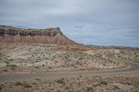 a long straight road that is surrounded by mountains in the desert area of an open plain