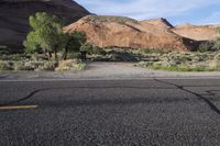 a dirt patch in between two dirt hills with a single bicycle on it and a stop sign next to it