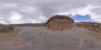 a large rock formation on a rocky surface near the desert with no people visible in the distance