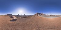 a 360 view of the landscape with mountains and rocks, some rocks are in the background and another is a desert area