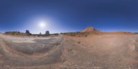 a 360 view of the landscape with mountains and rocks, some rocks are in the background and another is a desert area