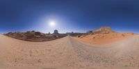 a 360 view of the landscape with mountains and rocks, some rocks are in the background and another is a desert area