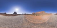 a 360 view of the landscape with mountains and rocks, some rocks are in the background and another is a desert area