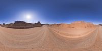 a 360 view of the landscape with mountains and rocks, some rocks are in the background and another is a desert area