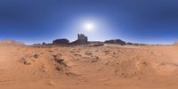 a 360 view of the landscape with mountains and rocks, some rocks are in the background and another is a desert area