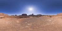 a 360 view of the landscape with mountains and rocks, some rocks are in the background and another is a desert area