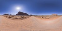 a 360 view of the landscape with mountains and rocks, some rocks are in the background and another is a desert area