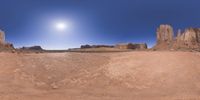 a 360 view of the landscape with mountains and rocks, some rocks are in the background and another is a desert area