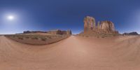 a 360 view of the landscape with mountains and rocks, some rocks are in the background and another is a desert area