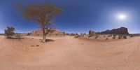 a 360 view of the landscape with mountains and rocks, some rocks are in the background and another is a desert area