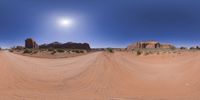 a 360 view of the landscape with mountains and rocks, some rocks are in the background and another is a desert area