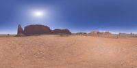 a 360 view of the landscape with mountains and rocks, some rocks are in the background and another is a desert area