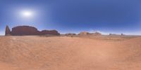 a 360 view of the landscape with mountains and rocks, some rocks are in the background and another is a desert area