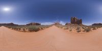 a 360 view of the landscape with mountains and rocks, some rocks are in the background and another is a desert area