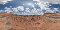 a 360 view of the landscape with mountains and rocks, some rocks are in the background and another is a desert area