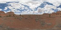 a 360 view of the landscape with mountains and rocks, some rocks are in the background and another is a desert area