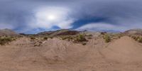 a view of a very large dirt field with a small amount of sand around it