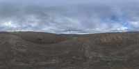 a big view of the clouds over the hill tops from within the panoramic