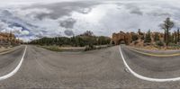 a 360 - degree lens view of a road with white lines on it is a mirror reflection