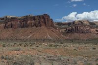 the wild horse is walking through the mountains and desert land near the mountains of the navajo