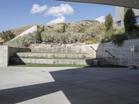 a large courtyard with stairs in the middle of it and grassy lawning outside the walls