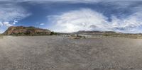 a fish - eye view of a desert landscape in a virtual format, with sky background