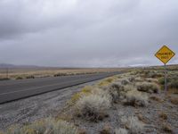 a road sign is on an empty road and it's not raining or clouds