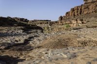 the rocky terrain is completely covered in rocks and plants along with the sky above them