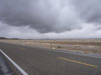 this is a wide open, deserted highway with a yellow line on the street to the right of the picture