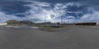 a 360 - degree photo shows the street and hills in the back ground, on a sunny day